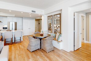 Enjoy meals in the kitchen and dining area with a round table and wicker chairs.
