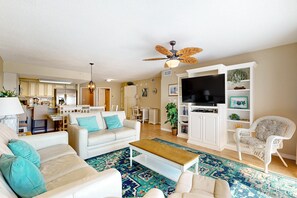 Relax in this stylish living room with a sofa, armchair, and flat-screen TV.