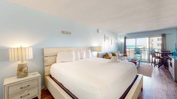 Relax in a spacious room with a large bed, sofa, and balcony offering ocean views.