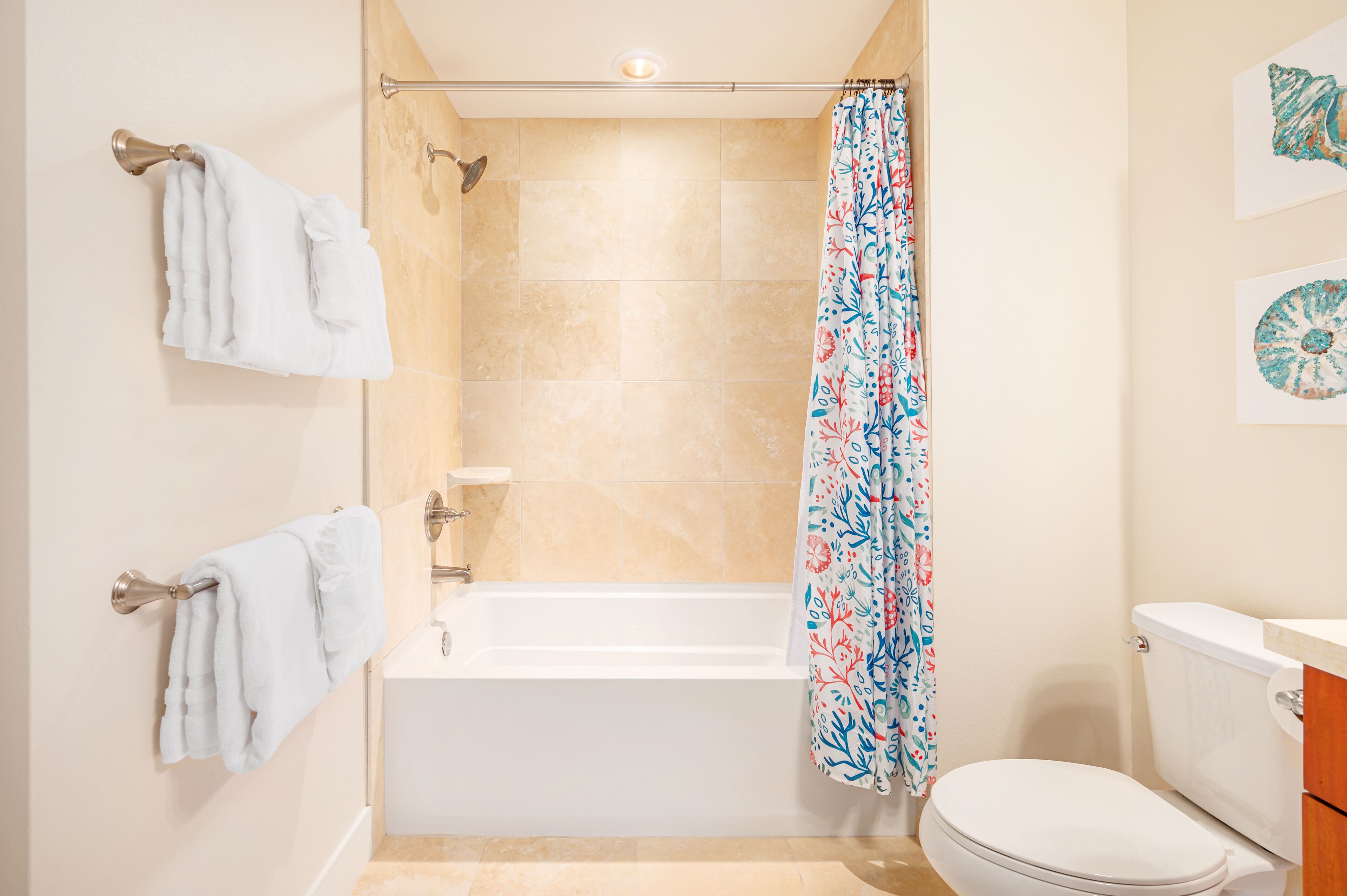 A bathroom with a bathtub, toilet, and a shower curtain.