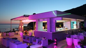 Un bar situé sur le toit, avec une terrasse et une vue sur la mer.