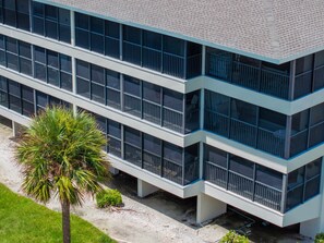A modern multi-story building with large windows and balconies. - Stunning Gulf Front Three Bedroom Sanibel Condo (Sanibel)