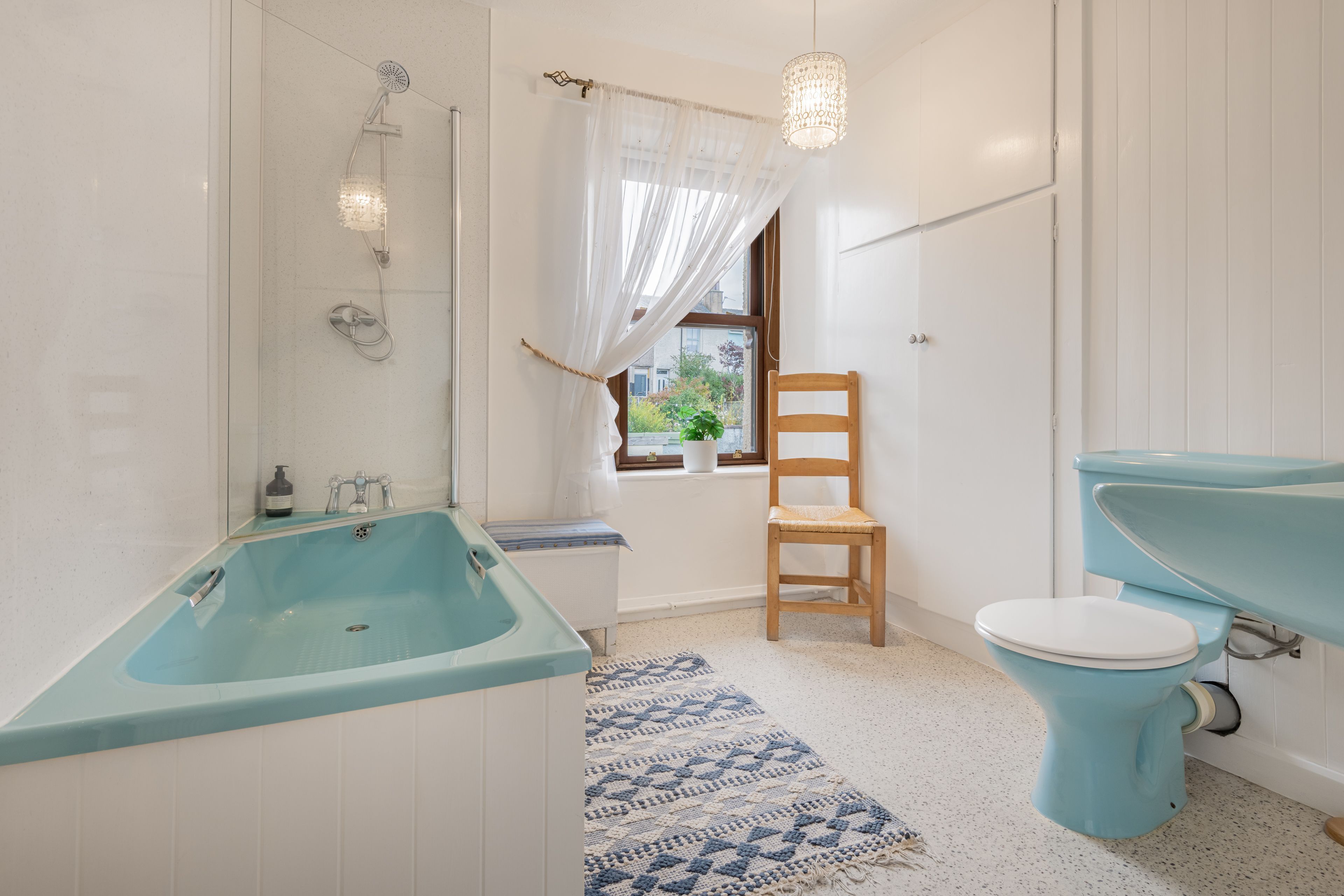 A bathroom with a bathtub, toilet, and shower.
