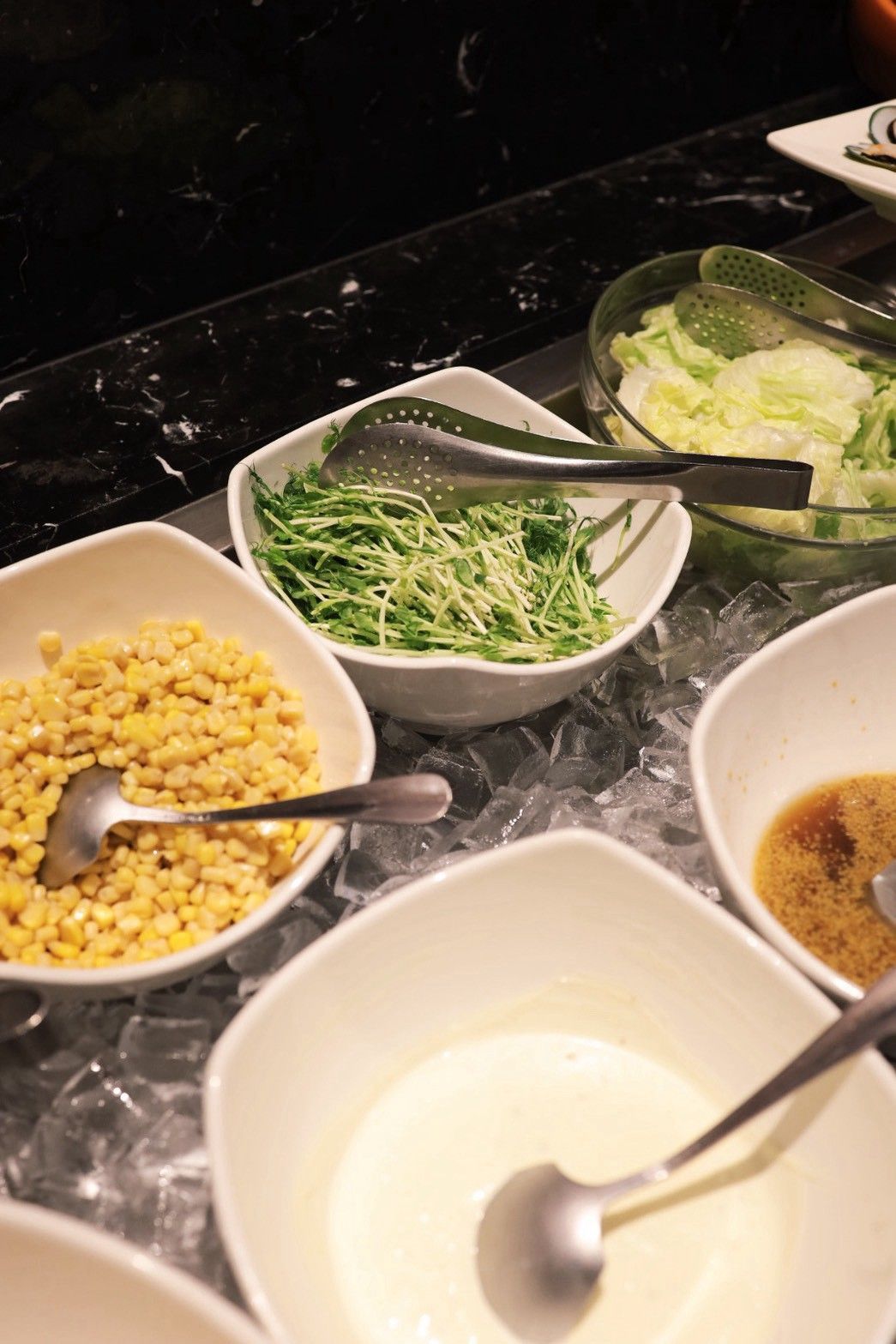 Bowls of food ingredients on a marble countertop.