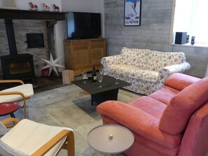 Relax in a warm and inviting space with a comfortable seating area, flat-screen TV, and decorative touches.