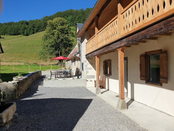 Traditional chalet-style building with a patio area and outdoor seating.