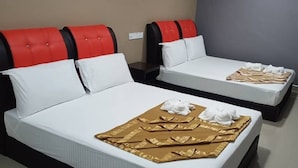 Two beds with red headboards and white bedding, each with towels and a folded brown cloth on the beds. - New Wave Cyberjaya Hotel (Cyberjaya)