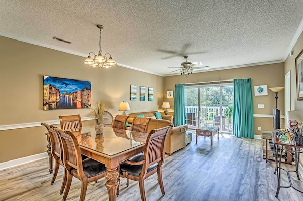 Enjoy meals in this stylish dining area with a large glass-top table and comfortable seating.