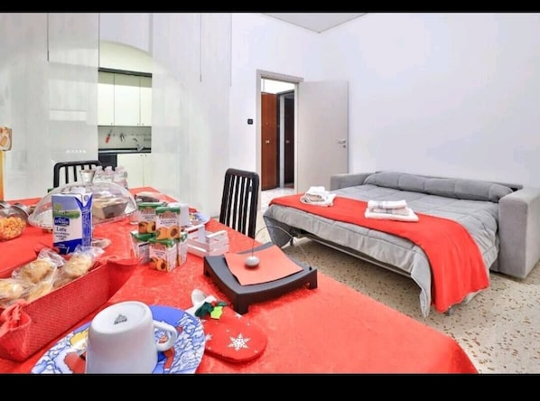 Relax in this serene space with a single bed, sofa, and breakfast table.