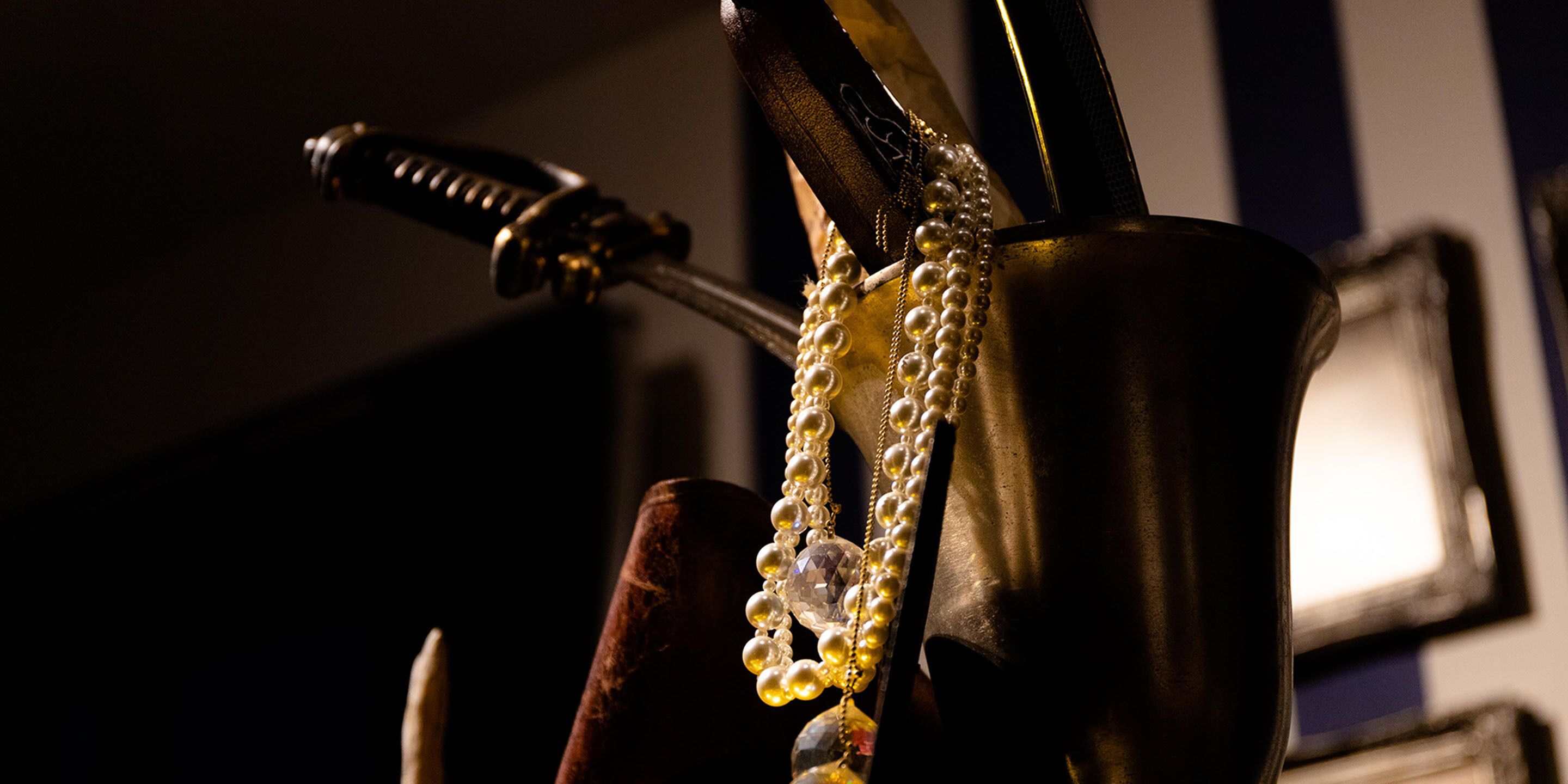 A close-up of a decorative object with a chain of pearls and a crystal pendant.