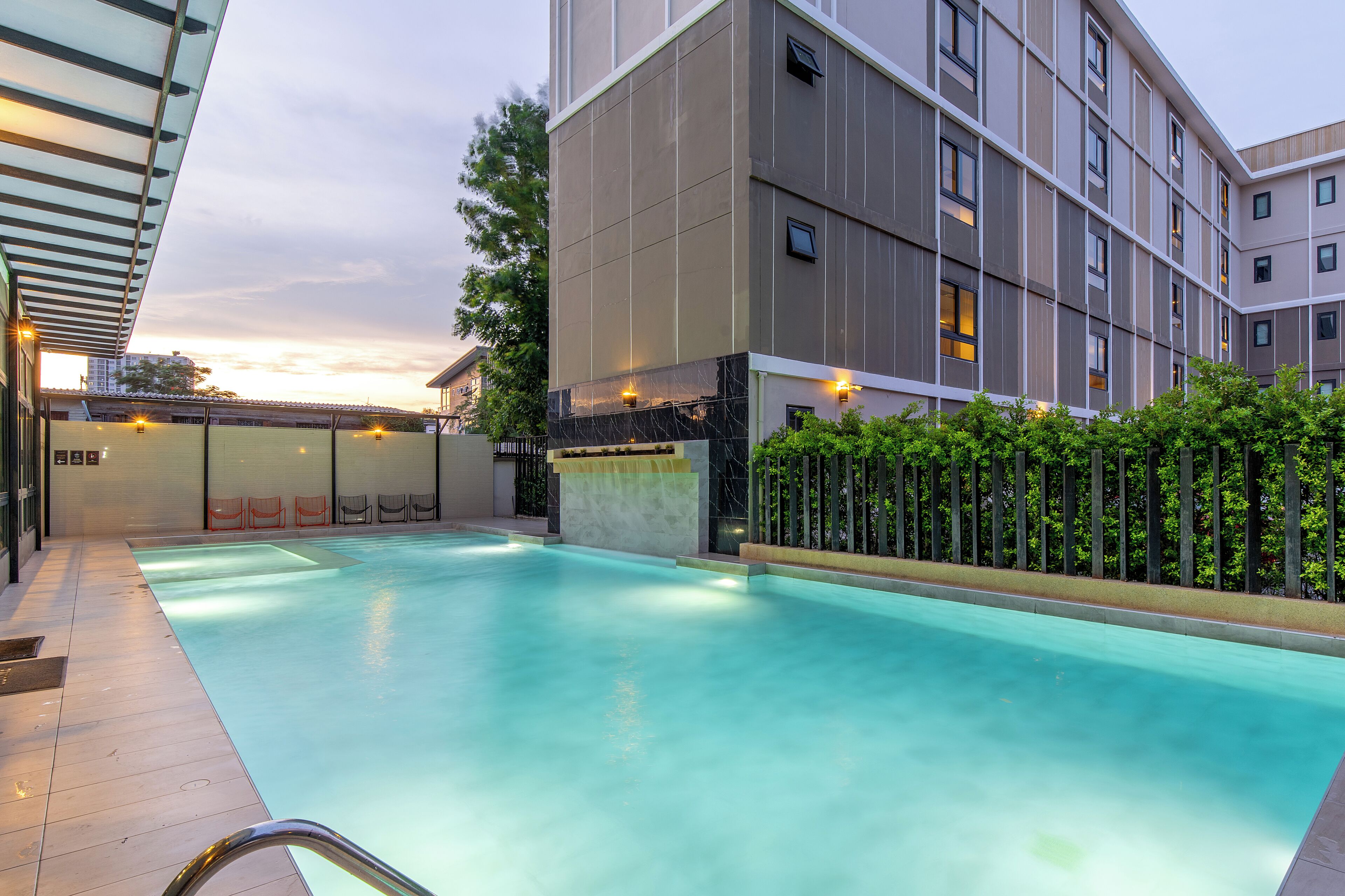 A swimming pool with a modern building in the background.