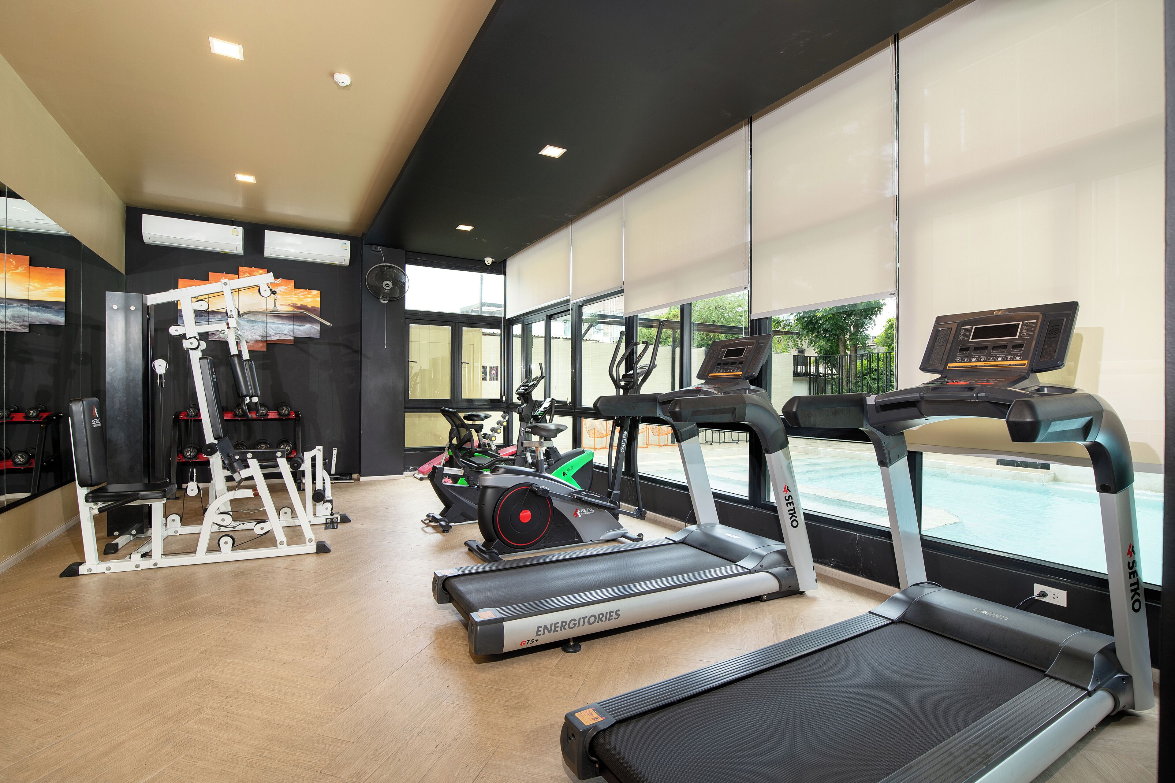 A gym with treadmills, ellipticals, and weight machines.