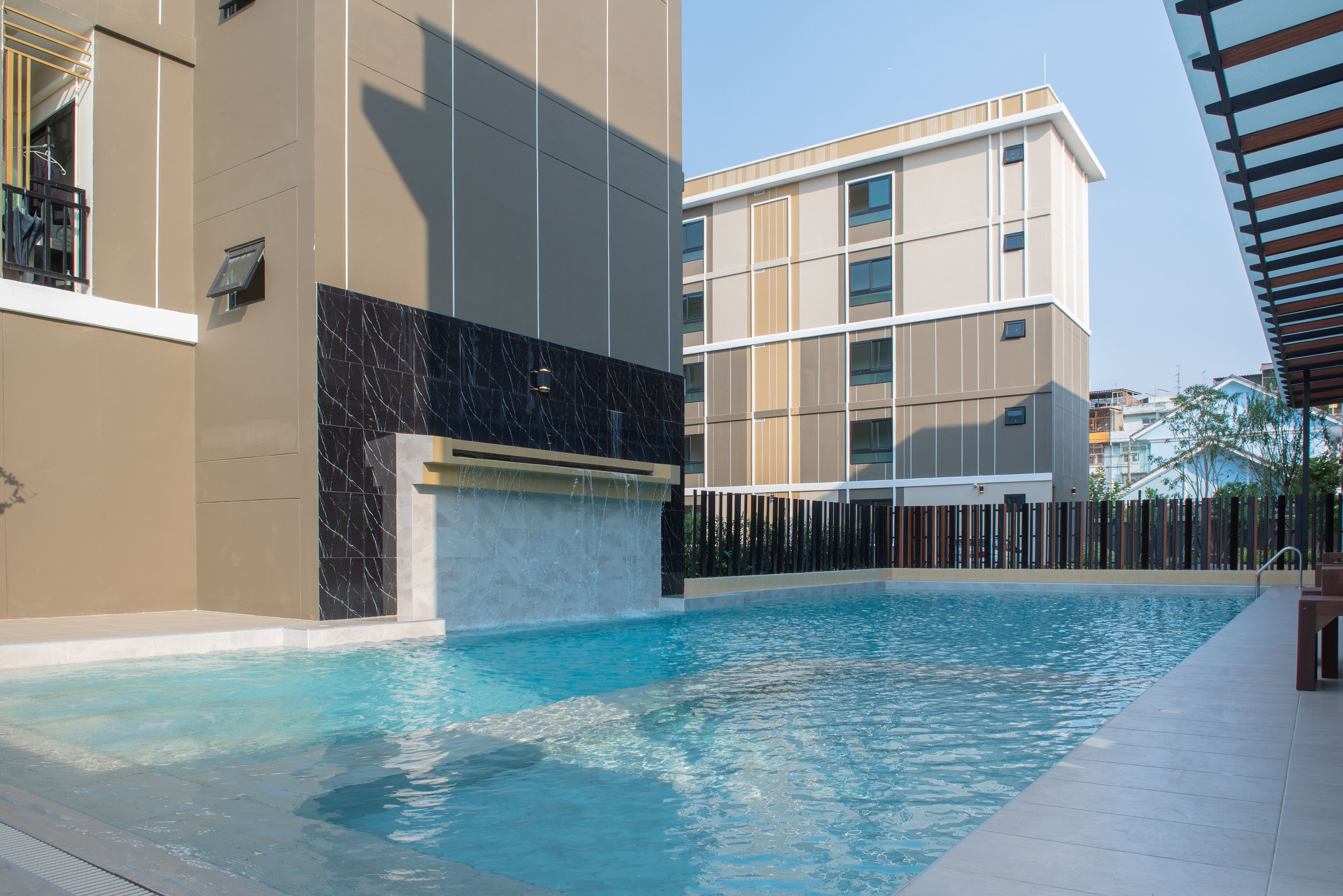A swimming pool with a modern building in the background.
