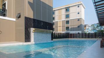 A swimming pool with a modern building in the background.