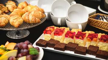 Un buffet proposant des pâtisseries, des fruits et des desserts.