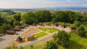 A campsite with multiple wooden cabins, a playground, and a picnic area. - Weedingshall Lodges (Falkirk)