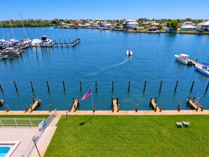 A marina with boats docked, a flag, and a clear view of the surrounding area.