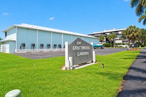 A building with a sign reading '220 DRIFTWOOD LANDING' and a parking lot in front.