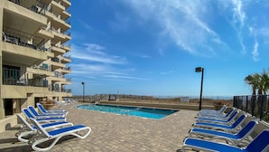 A poolside area with lounge chairs and a clear view of the ocean. - Tidemaster. 3 bedroom oceanfront condo 1st floor with elevator. Pool. (North Myrtle Beach)