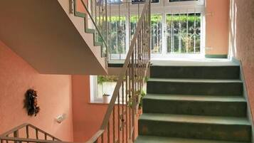 A staircase with a metal railing leading to a landing.