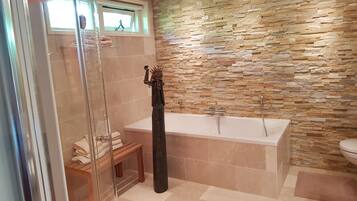 Bathtub, hair dryer, towels, soap