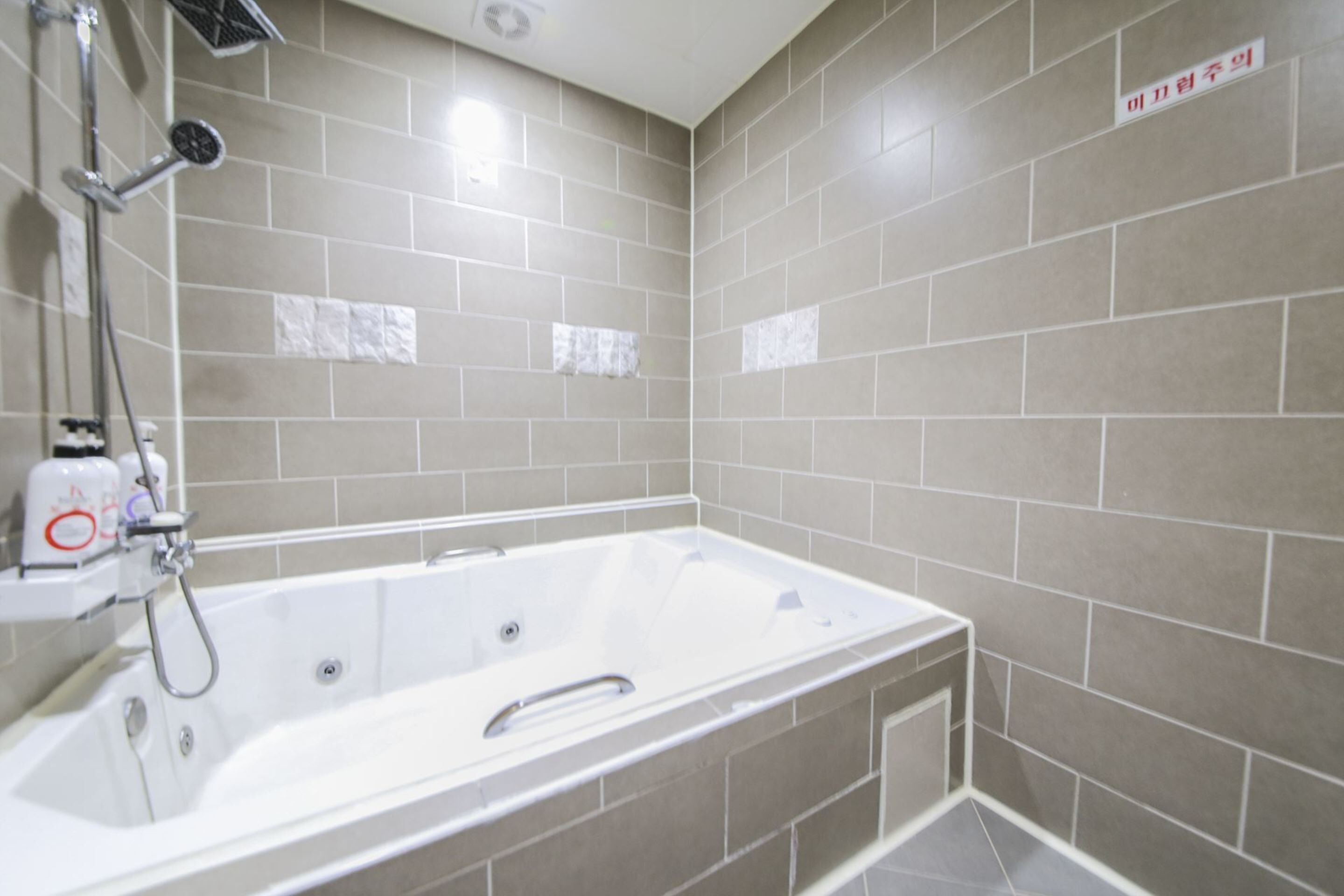 luxury room | bathroom | combined shower/bathtub, hair dryer, towels, soap