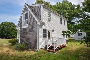A two-story house with a gabled roof and a front porch.