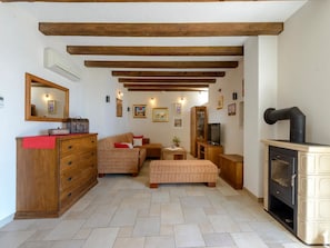 Relax by the fireplace in this inviting living room with a sofa set, round table, and TV.