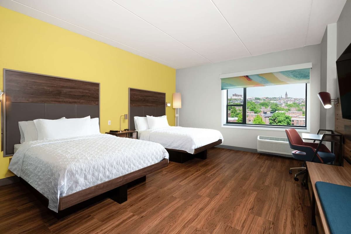 Hypo-allergenic bedding, desk, laptop workspace, blackout drapes