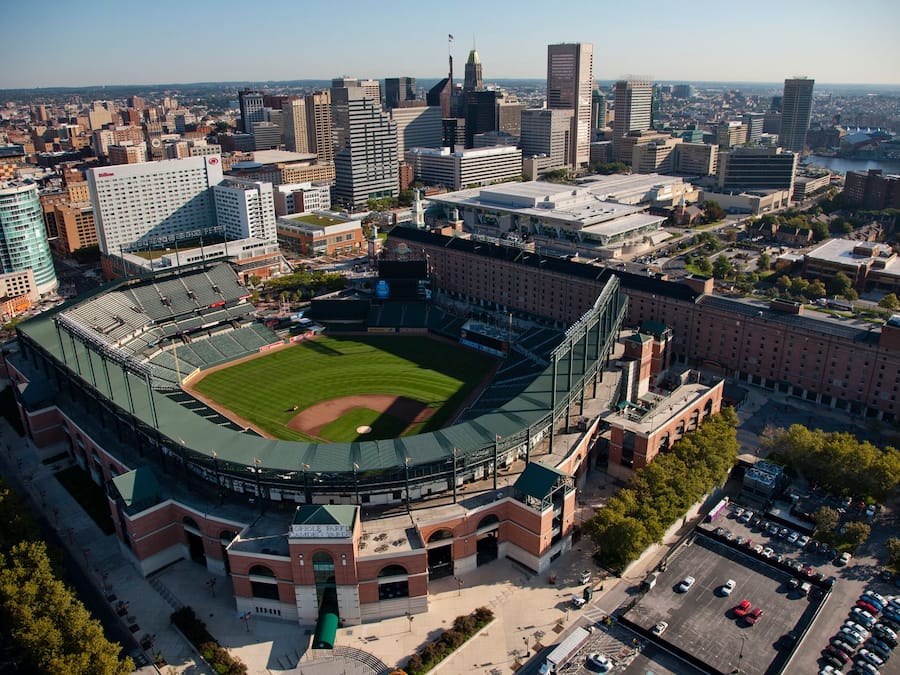 A large stadium surrounded by urban buildings, with a clear view of the field and seating areas.