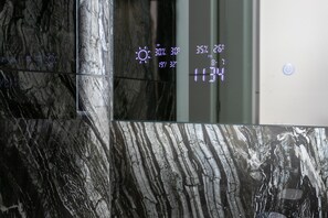 Un mur de marbre doté d’un écran numérique affichant des informations météorologiques.