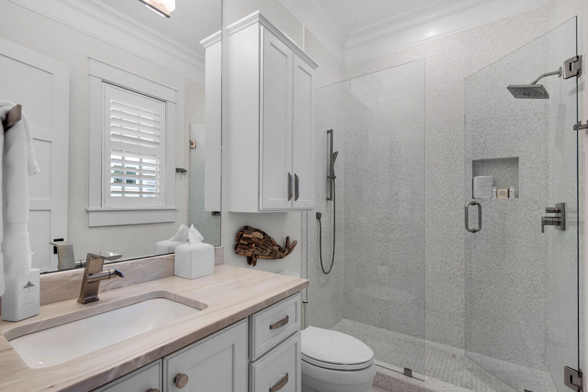 A modern bathroom with a sink, toilet, and shower.