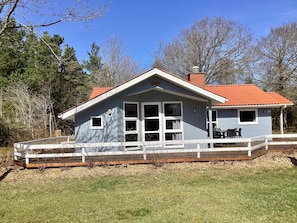A two-story building with a covered porch and a fenced deck. - Holiday Home in NÃ¸rre Nebel (Norre Nebel)