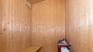 A sauna room with wooden walls and a bench. - Holiday Home in NÃ¸rre Nebel (Norre Nebel)