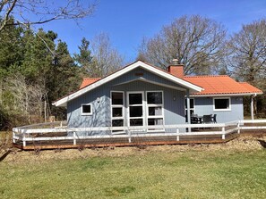 A two-story building with a covered porch and a fenced deck. - Holiday Home in NÃ¸rre Nebel (Norre Nebel)