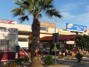 Enjoy dining and socializing in this vibrant commercial area with outdoor seating and a variety of local eateries.