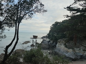 A coastal view with rocky cliffs, a wooden lookout platform, and a calm sea. - PORNIC T2 facing and sea view beach 50m, Thalasso 300m (Pornic)