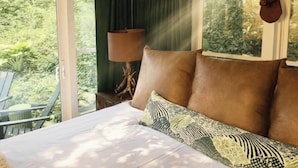 A bedroom with a bed, a lamp, and a deer head mounted on the wall. - Live-in Art Gallery in Downtown Highlands / Walk to Main Street / Mountain Views (Highlands)