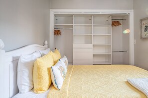 Restful retreat with a neatly made bed and ample storage space.