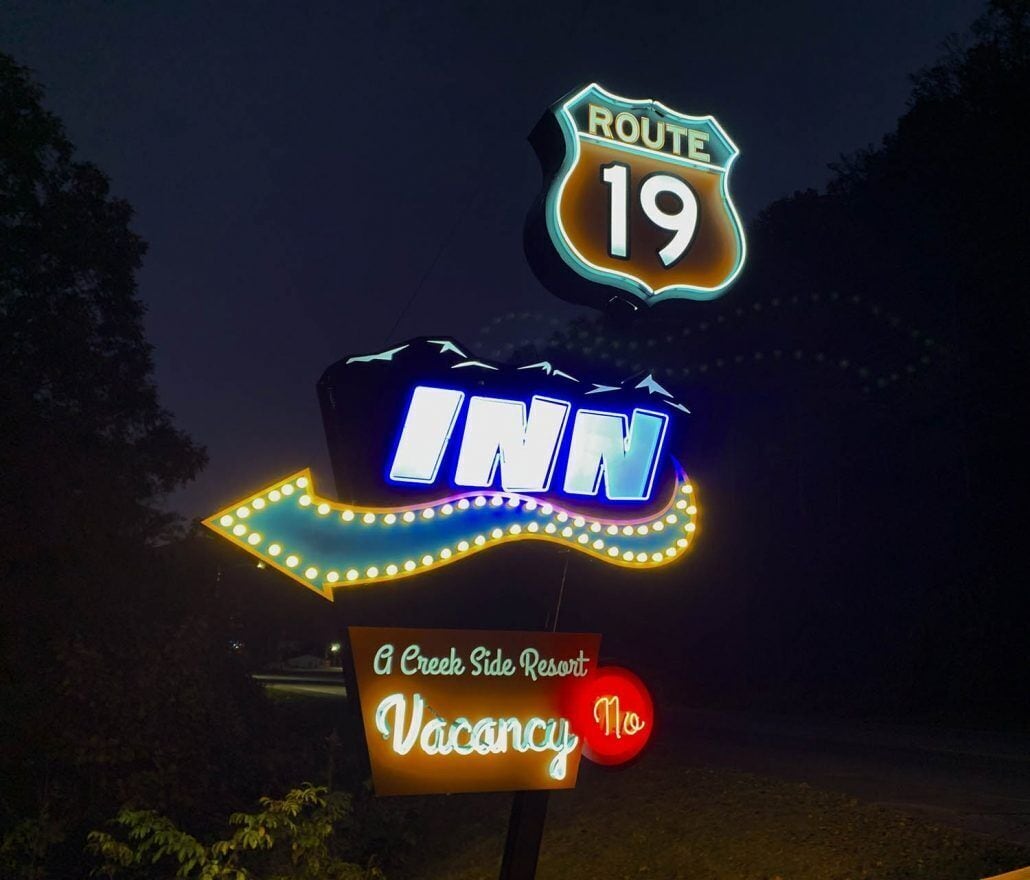 A neon sign for a Route 19 Inn with a 'Vacancy No' sign below it.
