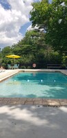 Seasonal outdoor pool, open 10:00 AM to 8:00 PM, pool umbrellas