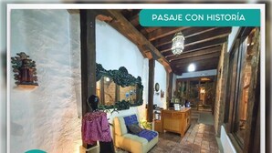 Un intérieur chaleureux avec un canapé, un miroir et un plafond en bois.