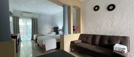 Standard Suite, Multiple Beds, Non Smoking, Balcony | Living area | 32-inch Smart TV with digital channels