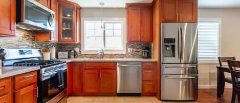 Fridge, microwave, cookware/dishes/utensils, dining tables