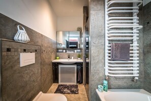 Bathtub, towels, toilet paper