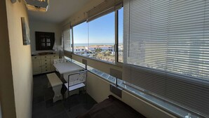 A room with a large window, a desk, and a chair. - Spacious apartment for 4, balcony, sea view, near beach, parking, cleaning included (Saint-Hilaire-de-Riez)