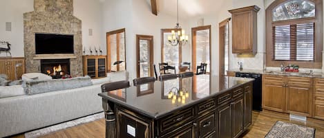 Kitchen, looking into the Grand room with fireplace.
