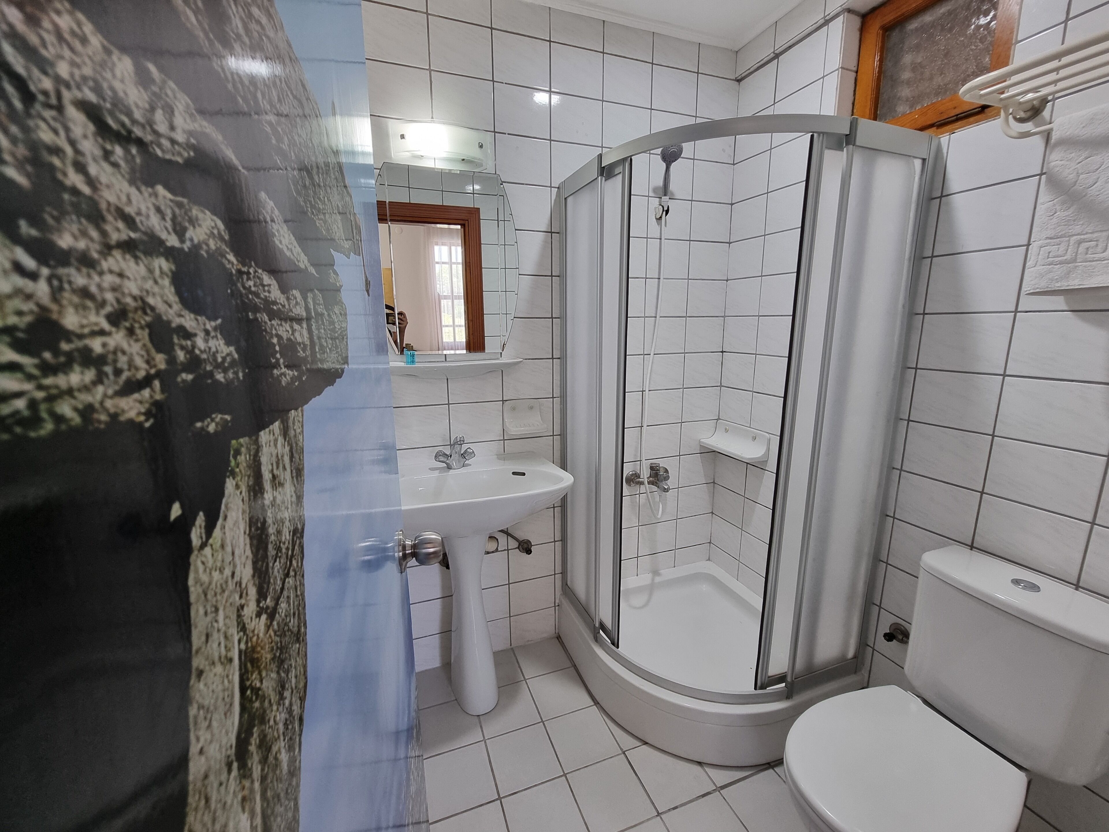 shower, hair dryer, slippers, towels