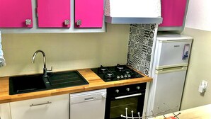 A compact kitchen with a sink, stove, dishwasher, and refrigerator. - VILLA 200 M from the BEACH (Sainte-Marie-la-Mer)