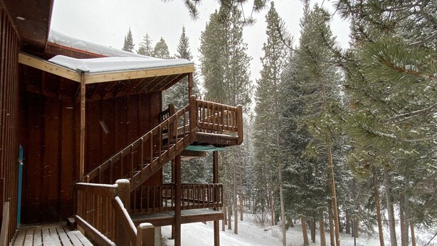 A wooden cabin with a wooden staircase leading to a deck. - Beautiful Mountain Getaway in Breckenridge, CO (Breckenridge)